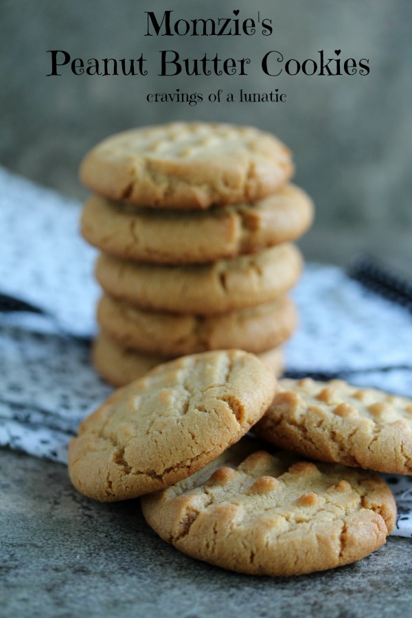 peanut butter cookies stacked on a cloth napkin