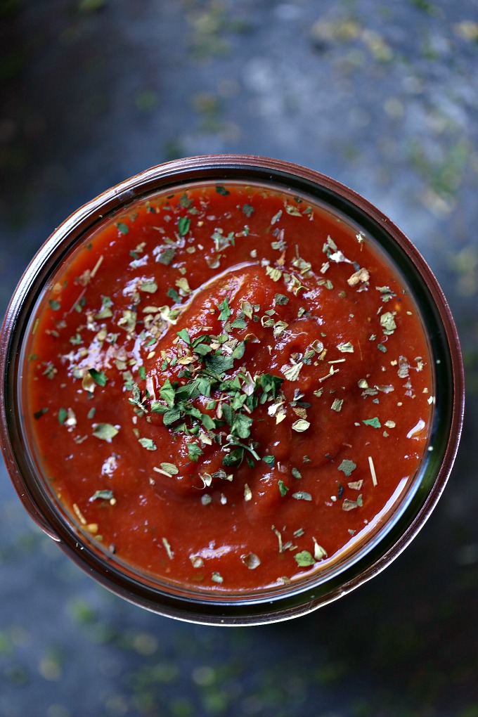 overhead image of slow cooker pizza sauce stored in a mason jar