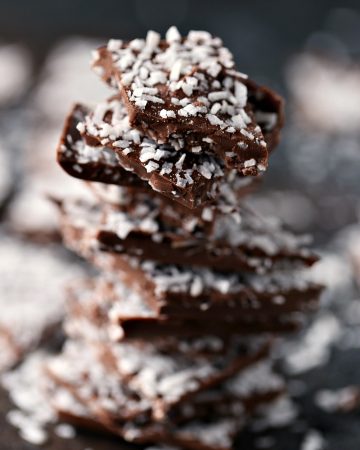 Chocolate Coconut Bark stacked with random pieces surrounding it.