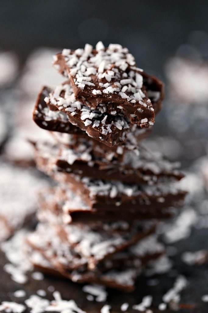 Chocolate Coconut Bark stacked with random pieces surrounding it. 