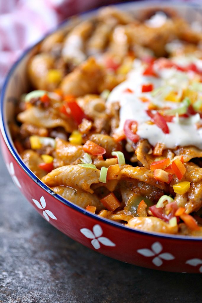 Slow cooker taco pasta served in a brightly coloured bowl.