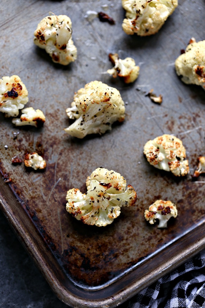 overhead image of roasted cauliflower cooked on a cookie sheet 