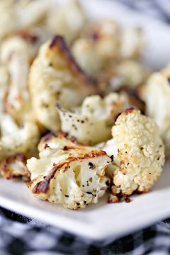 close up image of Roasted Cauliflower from cravingsofalunatic.com. Roasted Cauliflower is one of the easiest side dish recipes to make. The perk is it's also incredibly tasty. Roasting brings out the natural sweetness of the cauliflower. 