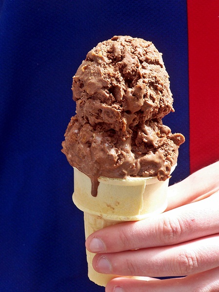 Cocoa pebbles ice cream served in a cone.
