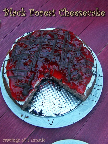 overhead image of Black Forest Cheesecake with a slice removed