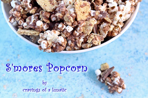 s'mores popcorn in a blue bowl with a piece on the counter