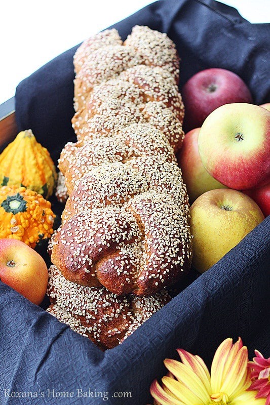 Whole Wheat Pumpkin Challah served in a basket with apples and mini pumpkins