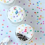 No bake cake served in jars with lots of sprinkles all over