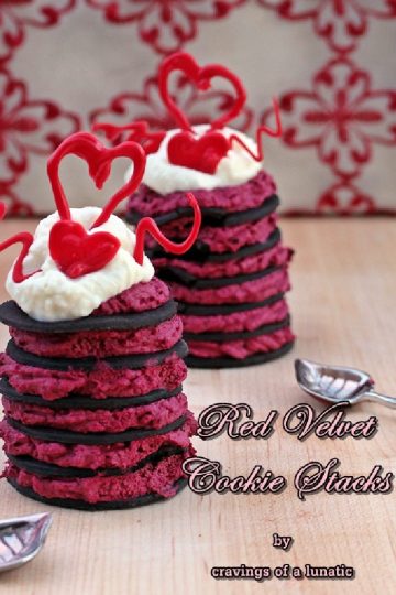 red velvet cookie stacks desserts on a wood board with spoons nearby