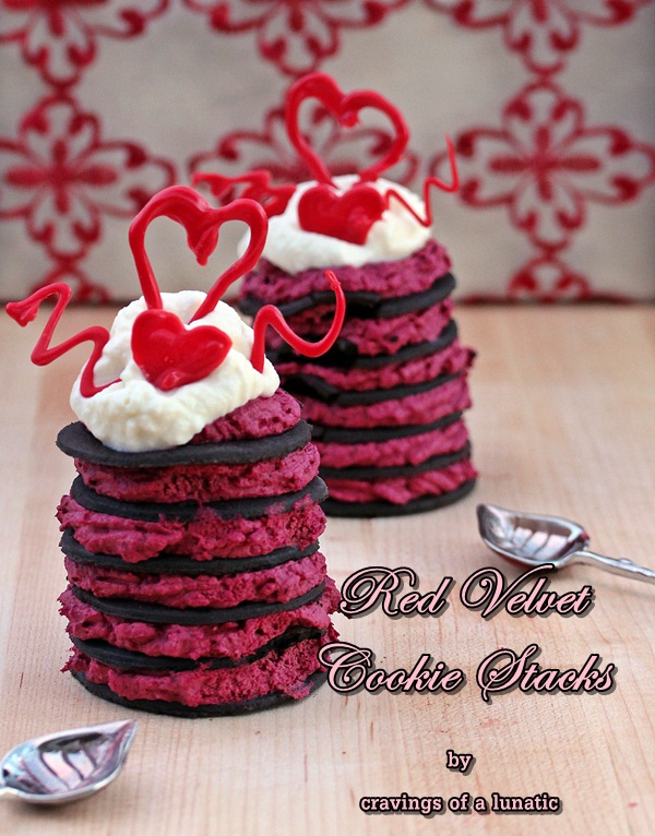 red velvet cookie stacks desserts on a wood board with spoons nearby
