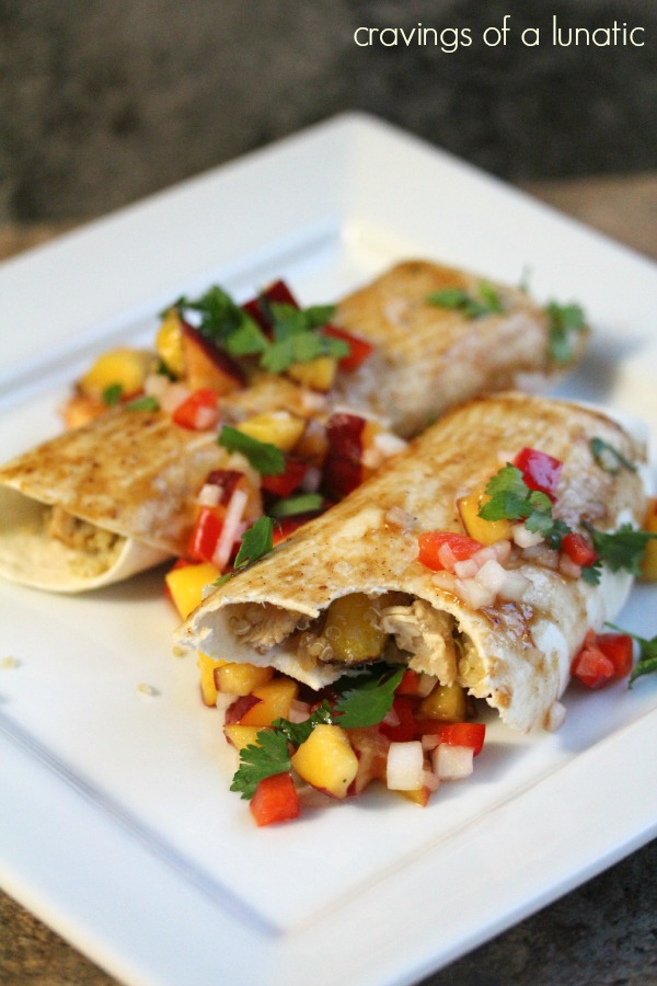 asian inspired chicken enchiladas stuffed with quinoa, chicken and peach salsa on a white plate