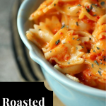 Roasted Red Pepper Pasta served in a blue bowl on a cloth napkin.