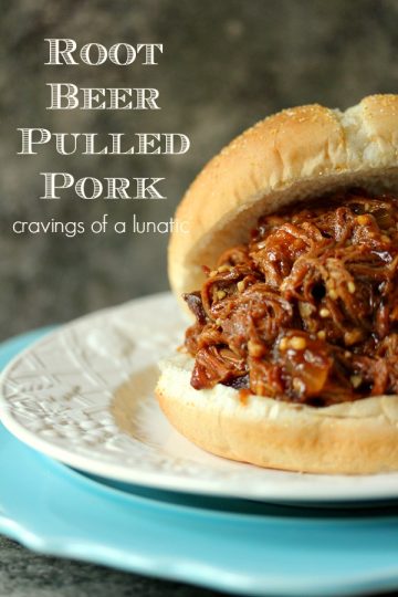 Slow Cooker Root Beer Pulled Pork served on a white plate stacked on a blue plate.