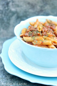 Roasted Red Pepper and Italian Sausage Pasta served in a blue bowl on a white plate