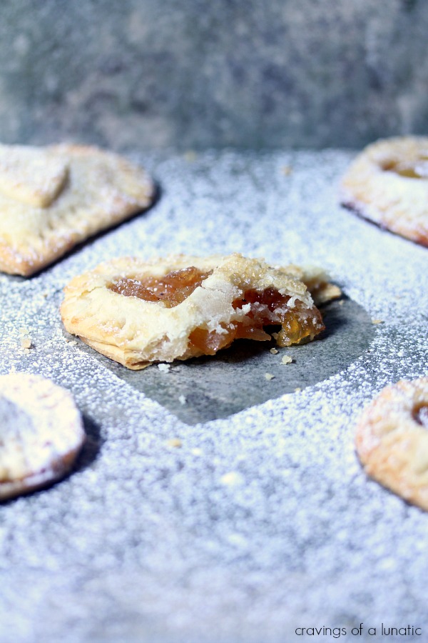 Apple Hand Pies on counter and sprinkled with powdered sugar