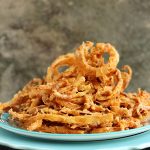 Onion Strings cooked to perfection and served on a colourful serving platter.