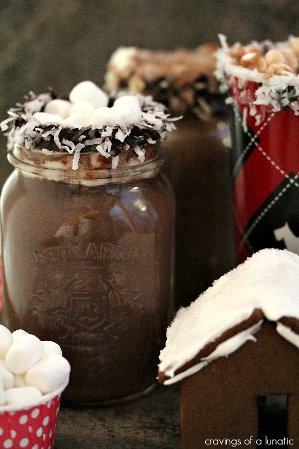 Coconut Hot Chocolate and Chocolate Covered Spoons on a dark counter.