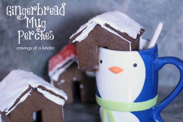 Mini Gingerbread House Hot Chocolate Mug Perches on penguin mug with more cookie houses in the background