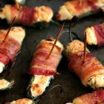 Jalapeno poppers stuffed with cheese and wrapped in bacon