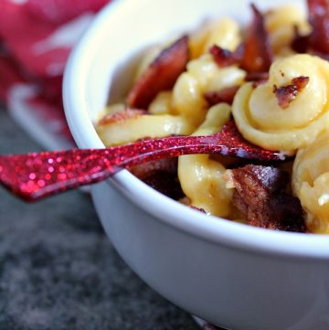 Smoked Bacon Mac and Cheese in a white bowl with a red spoon