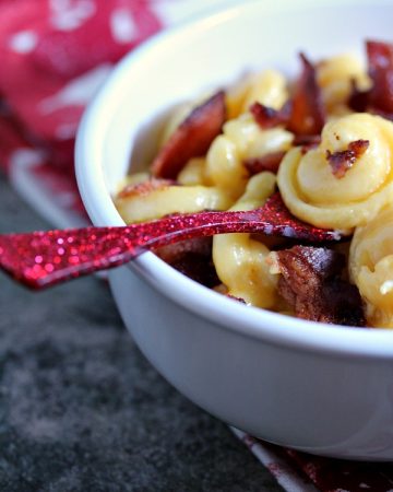 Smoked Bacon Mac and Cheese in a white bowl with a red spoon