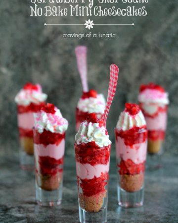 Strawberry Shortcake No Bake Mini Cheesecakes served layered in tall shot glasses with brightly colored spoons