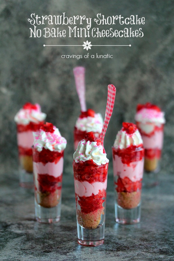 Strawberry Shortcake No Bake Mini Cheesecakes served layered in tall shot glasses with brightly colored spoons 