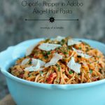 Roasted Red Pepper and Chipotle Pepper in Adobo Angel Hair Pasta served in a blue bowl and topped with parmesan cheese