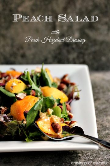 Peach Salad with Peach served on a white plate. Salad is drizzled with a Peach Hazelnut Dressing