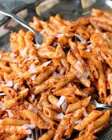 Penne Pasta with Sun-Dried Tomato Pesto served on a silver platter.