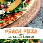 Pizza with Arugula, Peaches and Hazelnuts served on a wooden board