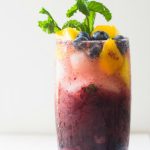 Blueberry Mango Mojito in a tall glass