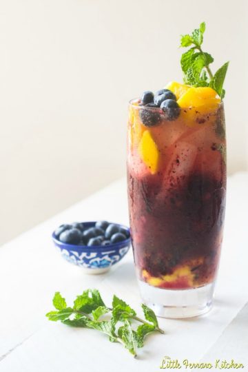 Blueberry Mango Mojito served in a tall glass