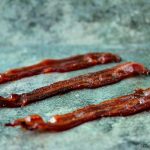 Strips of Candied Maple Bacon on counter