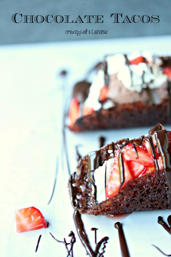 Chocolate Tacos filled with vanilla ice cream, chocolate ice cream, whipped cream and strawberries.
