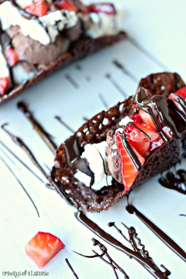 Chocolate Tacos filled with vanilla ice cream, chocolate ice cream, whipped cream and strawberries.