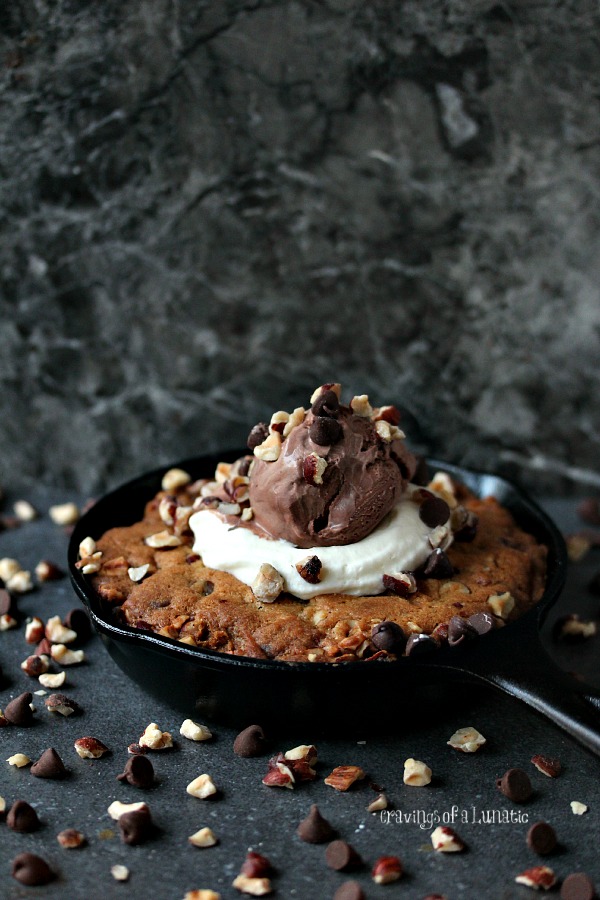 Chocolate Hazelnut Skillet Cookie with whipped cream and ice cream piled on top