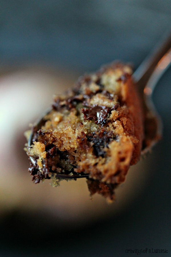 skillet chocolate chip cookie scooped up on a spoon for a close up view