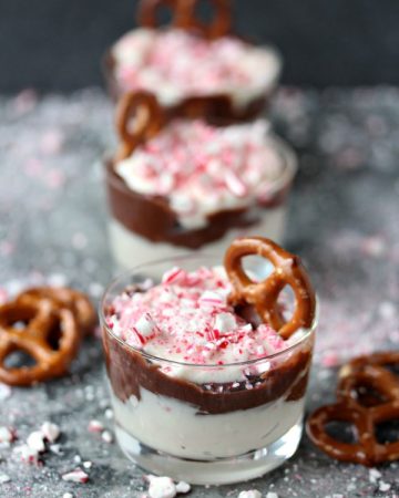 Peppermint Dip served in tiny glass jars with mini pretzels in them for scooping up the dip.