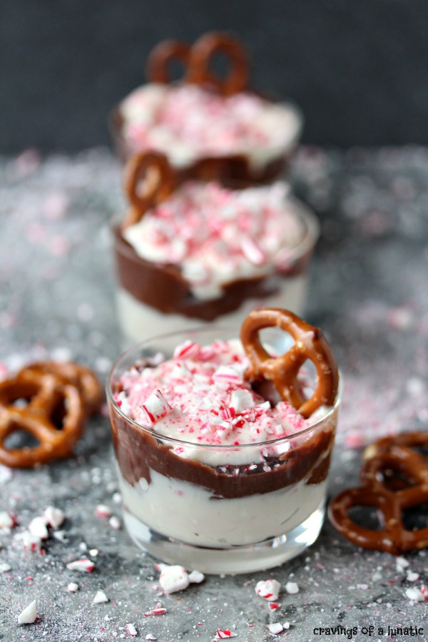 Peppermint Dip served in tiny glass jars with mini pretzels in them for scooping up the dip. 