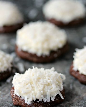 Chocolate coconut cookies on a grey marble surface.