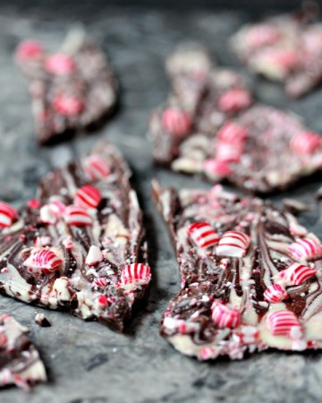 Chocolate Peppermint Bark broken into pieces and resting on a grey marble surface.