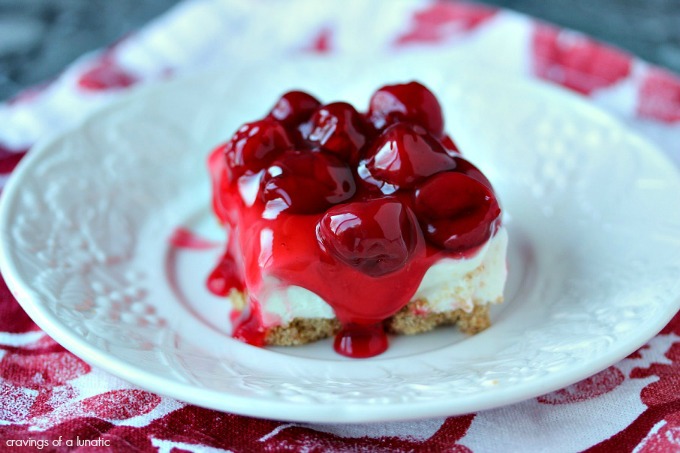 No Bake Cherry Cheesecake Bars served on a white plate. 