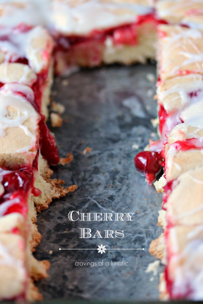 Cherry Bars aka Cherry Kuchen in a pan with some slices cut out.