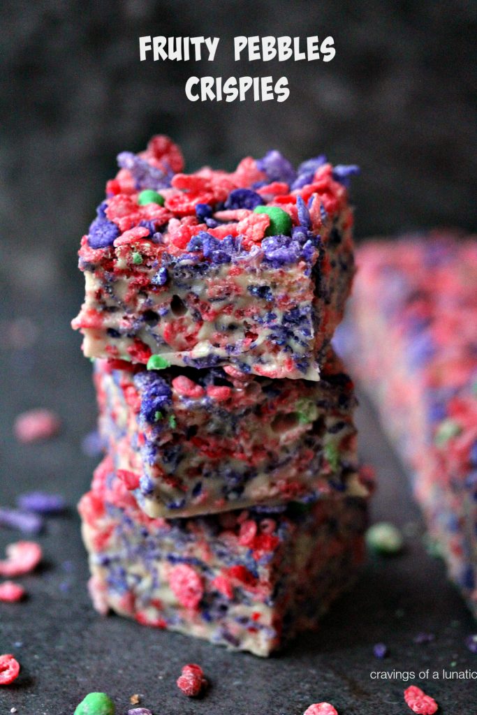 Fruity Pebbles Krispie Treats stacked on counter