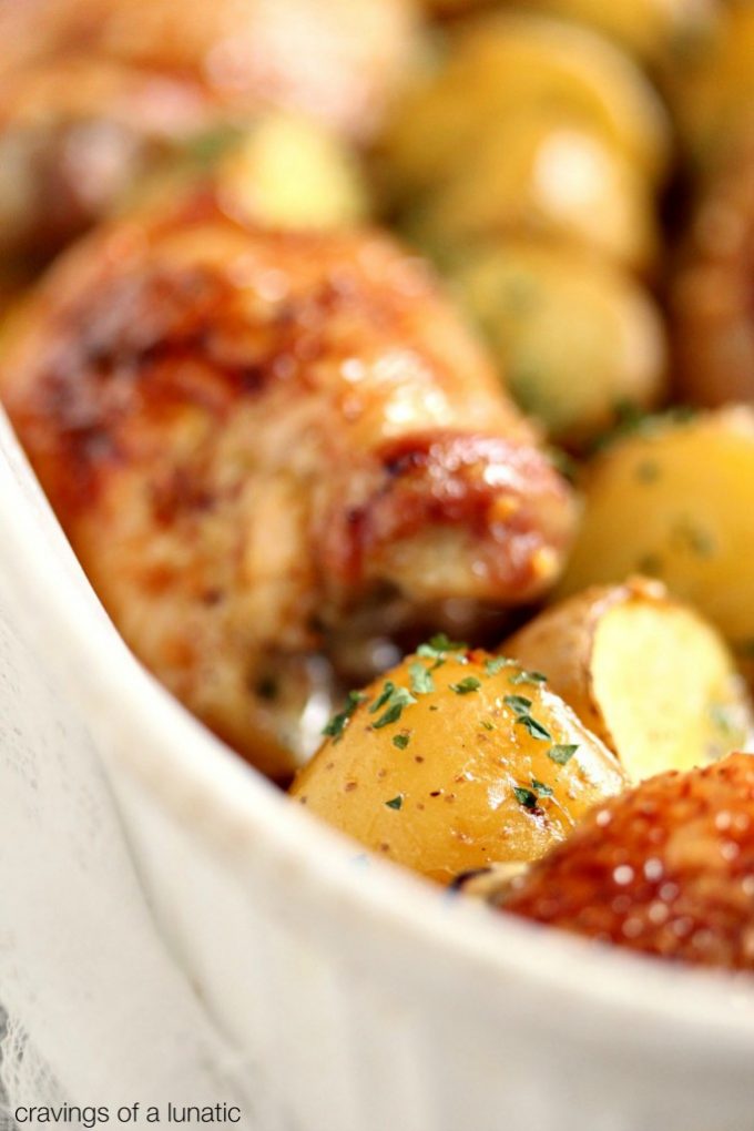 Honey Baked Chicken and Potatoes baked in a white baking dish