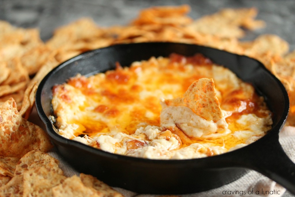 Buffalo Chicken Dip served in a cast iron skillet with chips nearby