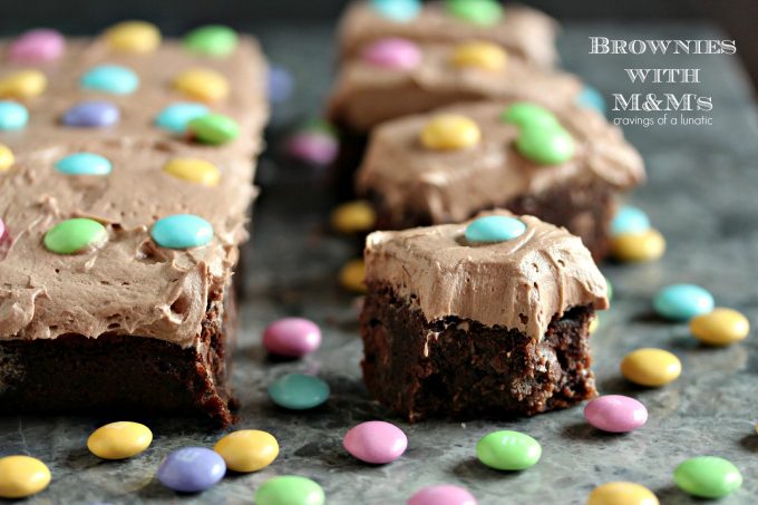 baked chocolate brownies with chocolate frosting and M&M candies 