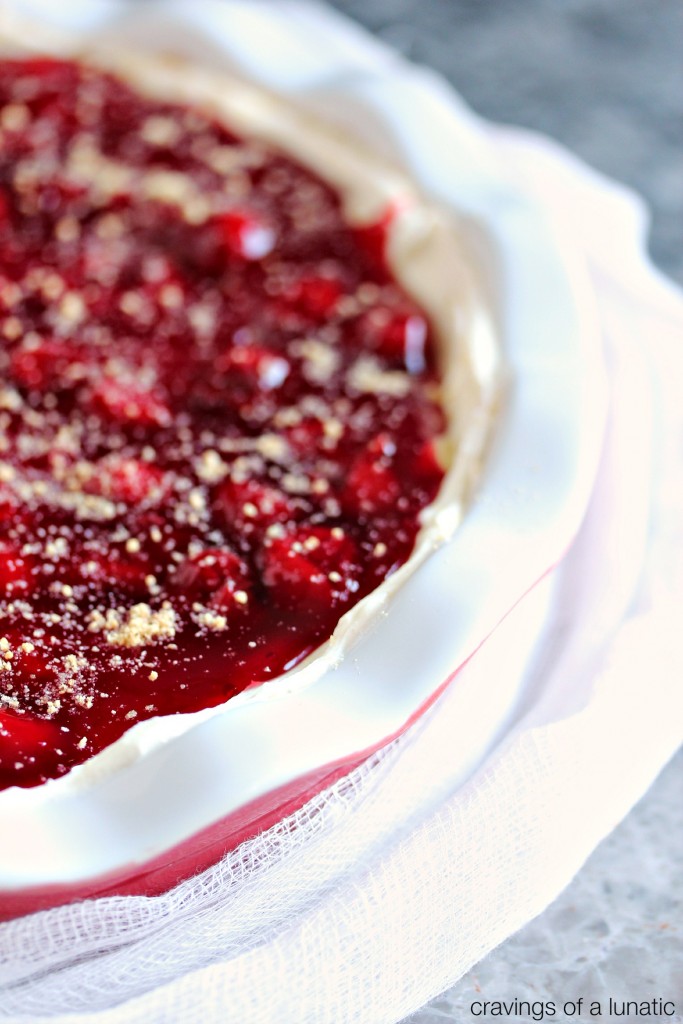 close up image of Cherry Cheesecake Dip with Cinnamon Pie Dippers in a red and white dish on a white cloth
