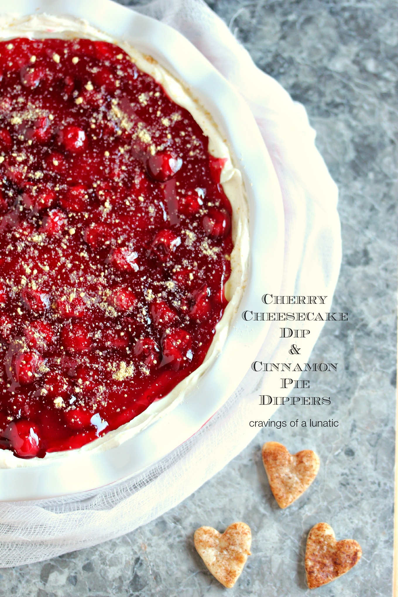 overhead image of Cherry Cheesecake Dip in a pie dish with Cinnamon Pie Dippers shaped like hearts